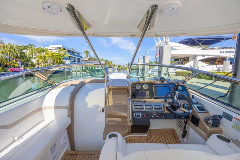 Slide: The Image of Cockpit view of a 2013 Formula 400 Super Sport boat with modern controls and luxurious seating. - 27