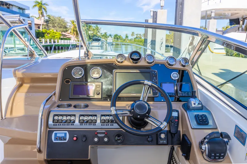 Slide: The Image of 2013 Formula 400 Super Sport boat dashboard with steering wheel and navigation controls. - 28
