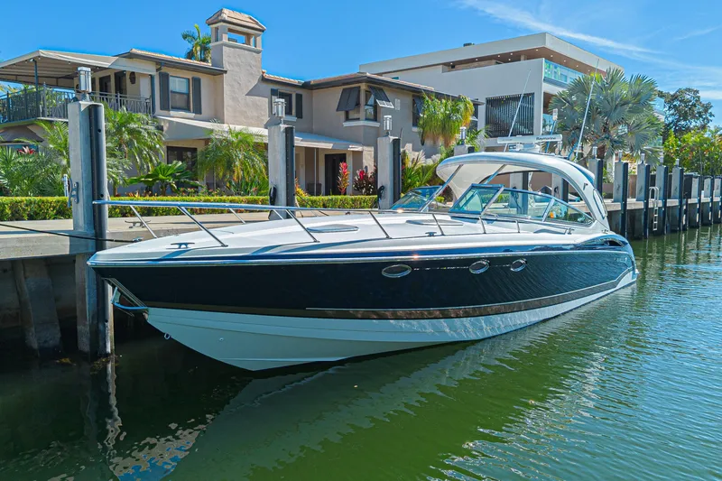 Slide: The Image of 2013 Formula 400 Super Sport boat docked by luxury waterfront homes. - 3