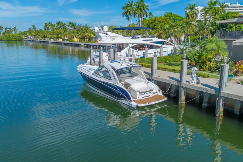 Slide: The Image of 2013 Formula 400 Super Sport yacht docked in a scenic marina with palm trees. - 8