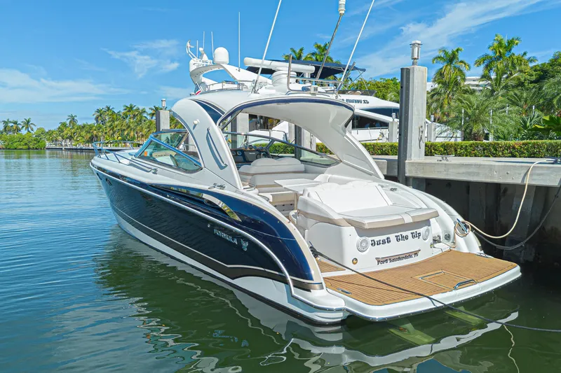 Slide: The Image of 2013 Formula 400 Super Sport yacht docked in sunny marina setting. - 9