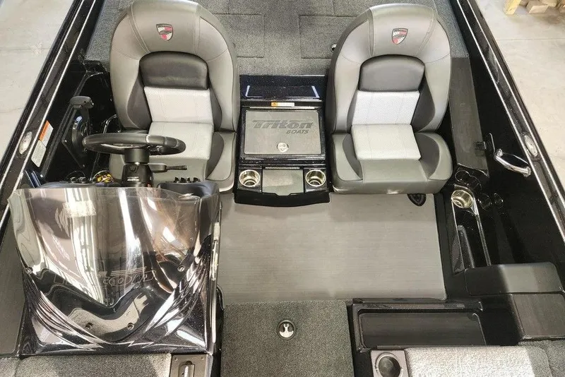 Slide: The Image of 2026 Triton 19 TrX Patriot boat interior with dual seats and steering console. - 11