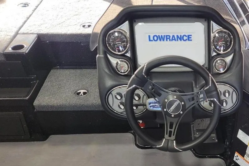 Slide: The Image of 2026 Triton 19 TrX Patriot boat dashboard with Lowrance display and steering wheel. - 3