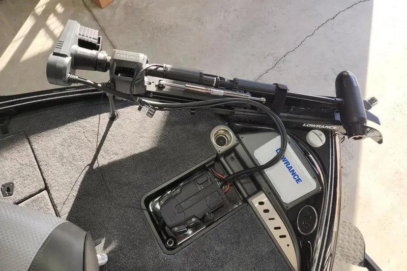 Slide: The Image of 2026 Triton 19 TrX Patriot boat deck with Lowrance equipment and trolling motor. - 5