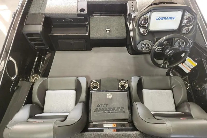 Slide: The Image of 2026 Triton 19 TrX Patriot boat interior with dual seats and Lowrance navigation system. - 6
