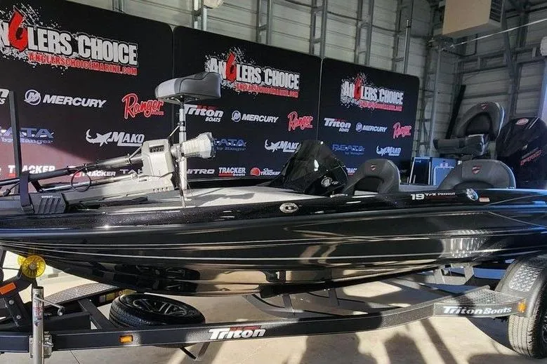 Slide: The Image of 2026 Triton 19 TrX Patriot boat displayed at Angler's Choice event. - 8