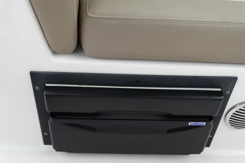 Slide: The Image of 2013 Regal 28 Express boat interior with beige seating and black storage compartment. - 20