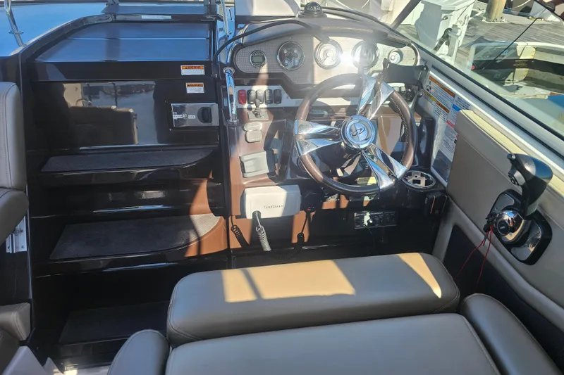 Slide: The Image of 2013 Regal 28 Express boat cockpit with steering wheel and control panel. - 21