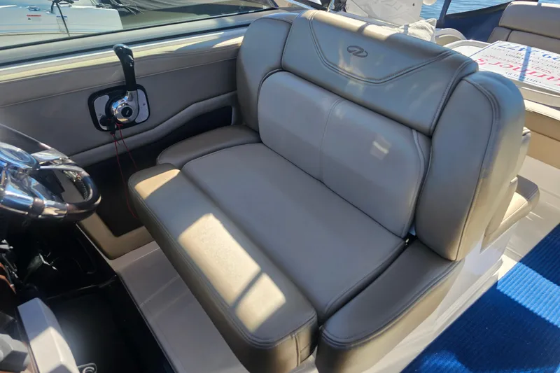 Slide: The Image of Luxurious seating on 2013 Regal 28 Express boat with steering wheel and control panel. - 22