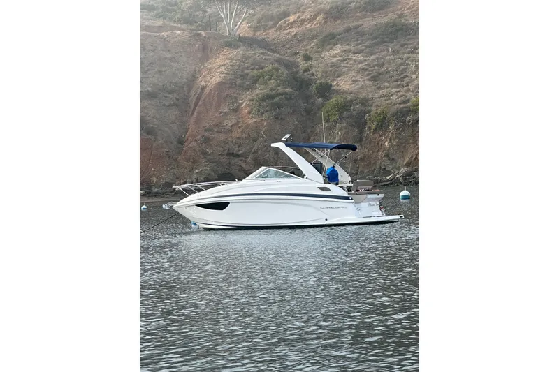 Slide: The Image of 2013 Regal 28 Express boat anchored in scenic coastal waters. - 4