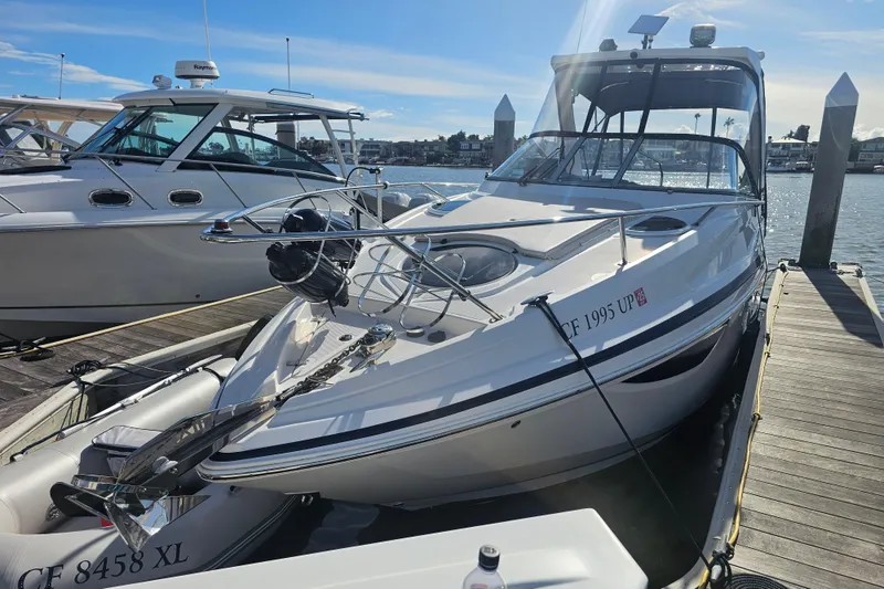 Slide: The Image of 2013 Regal 28 Express boat docked at marina under clear blue sky. - 9