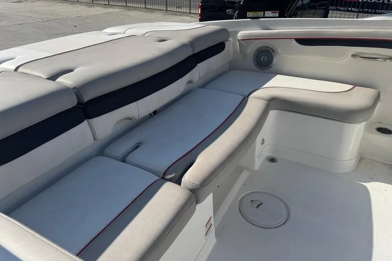 Slide: The Image of Interior seating of a 2018 Tahoe 700 TF boat, featuring cushioned benches and speaker. - 14