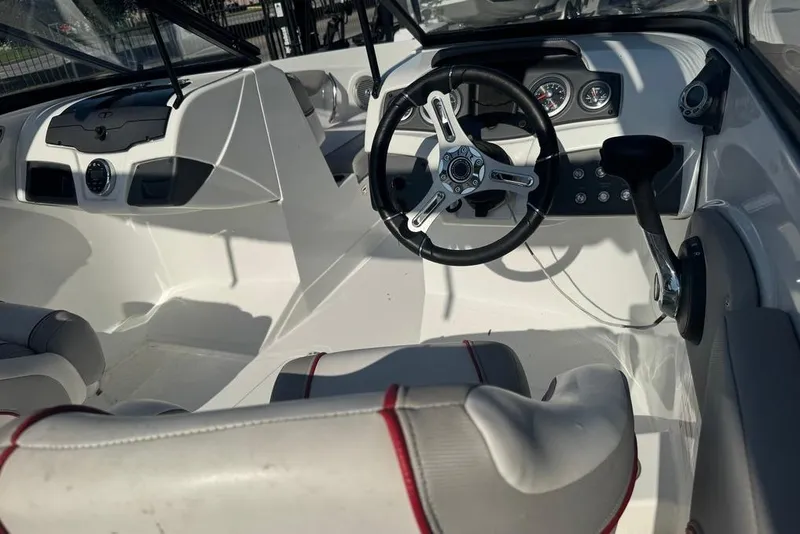 Slide: The Image of Interior of a 2018 Tahoe 700 TF boat, featuring steering wheel and dashboard controls. - 15