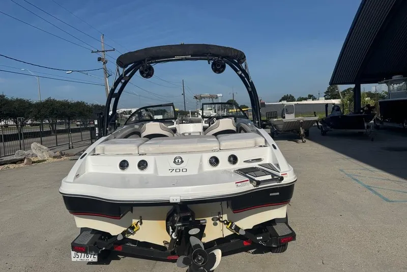 Slide: The Image of 2018 Tahoe 700 TF boat parked outdoors on a sunny day. - 6