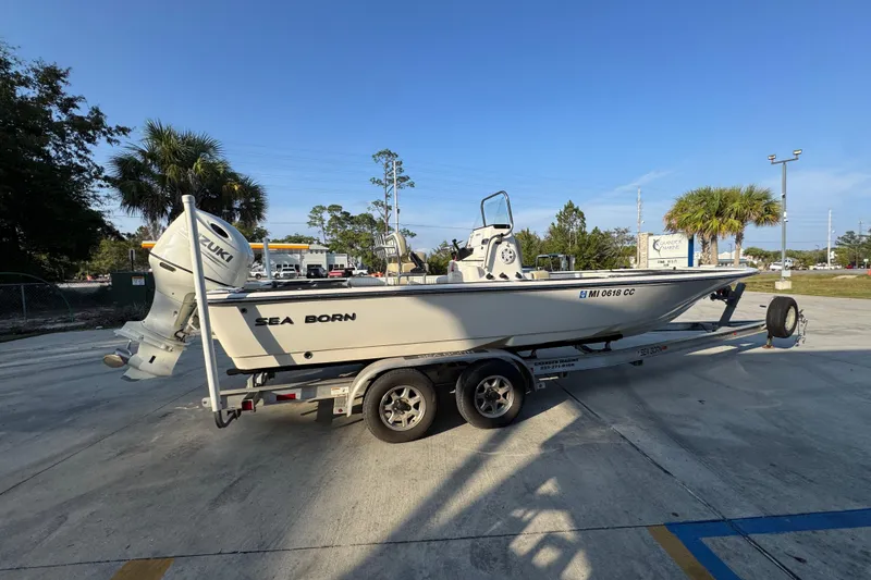 Slide: The Image of 2021 Sea Born FX24 Bay boat on trailer with Suzuki outboard motor. - 10