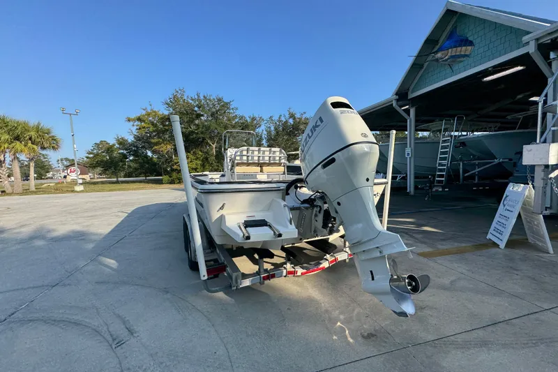 Slide: The Image of 2021 Sea Born FX24 Bay boat with Suzuki outboard motor in a marina setting. - 14