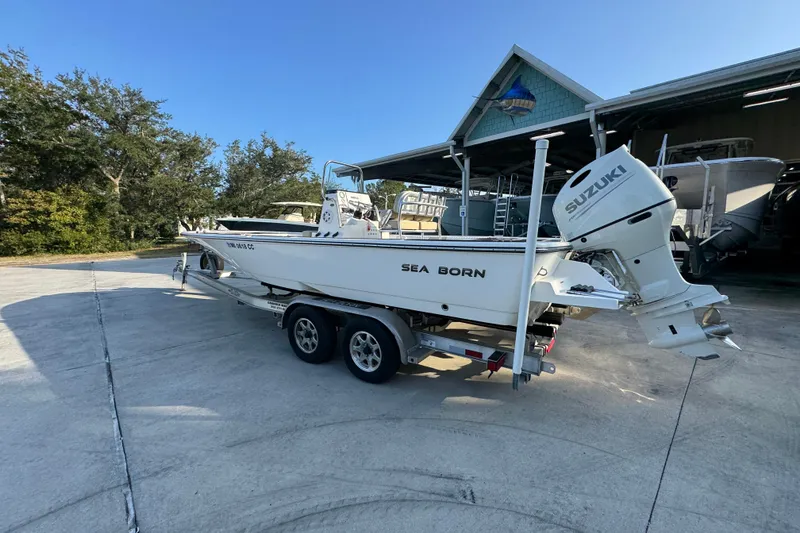 Slide: The Image of 2021 Sea Born FX24 Bay boat on trailer with Suzuki outboard motor. - 16