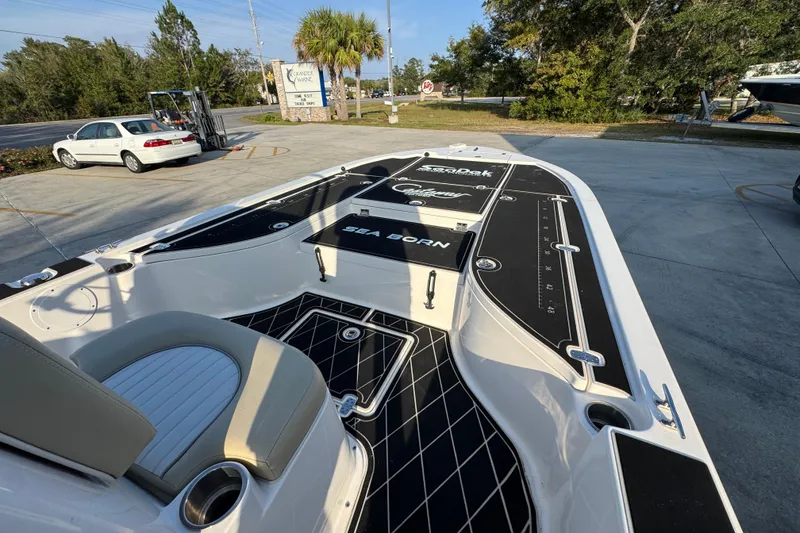 Slide: The Image of 2021 Sea Born FX24 Bay boat with sleek black and white deck design. - 17