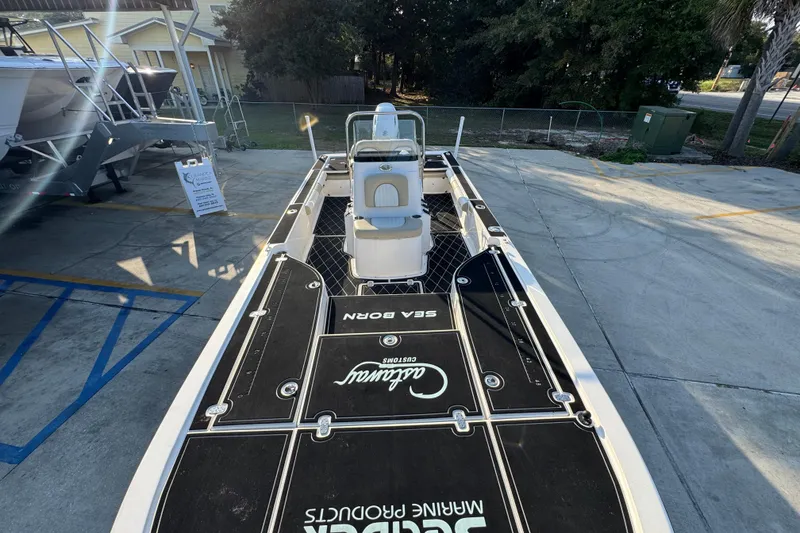 Slide: The Image of 2021 Sea Born FX24 Bay boat on display in a parking lot. - 21