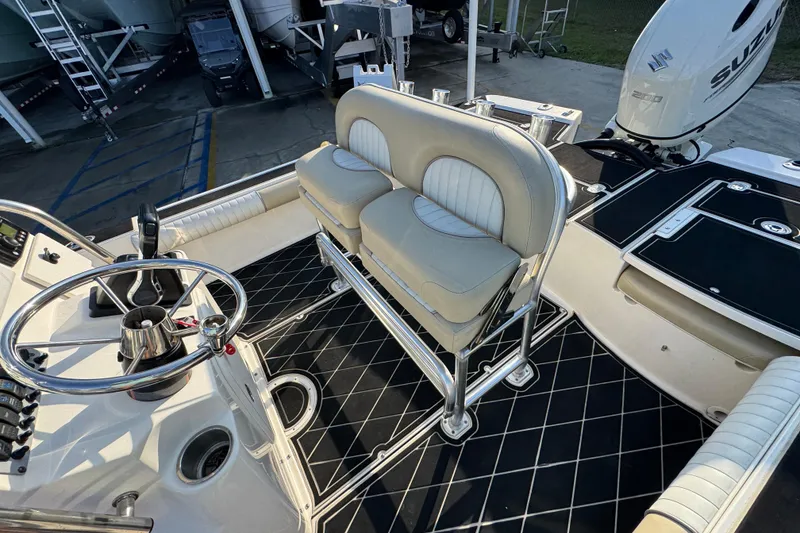 Slide: The Image of 2021 Sea Born FX24 Bay boat interior with steering wheel and seating. - 25