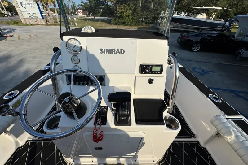 Slide: The Image of 2021 Sea Born FX24 Bay boat console with steering wheel and Simrad electronics. - 29
