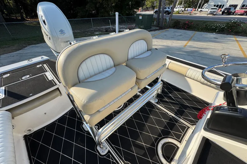 Slide: The Image of 2021 Sea Born FX24 Bay boat interior with cushioned seating and steering wheel. - 31