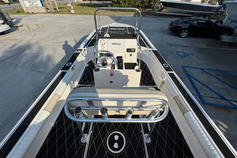 Slide: The Image of 2021 Sea Born FX24 Bay boat interior with steering console and rod holders. - 32