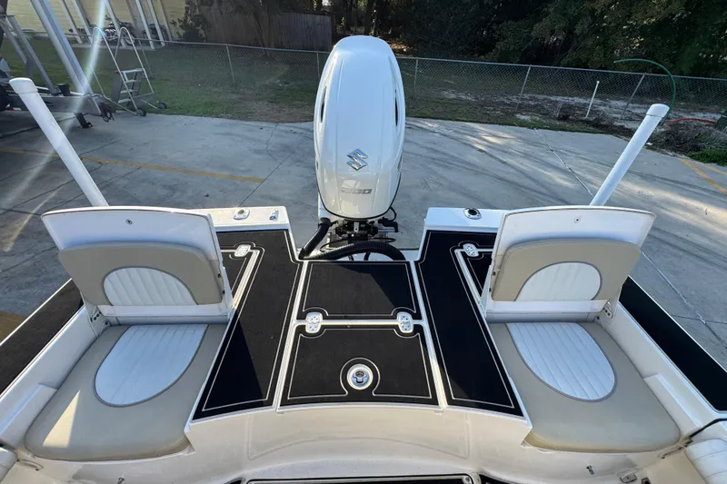Slide: The Image of 2021 Sea Born FX24 Bay boat deck with Suzuki outboard motor, featuring seating and storage. - 34