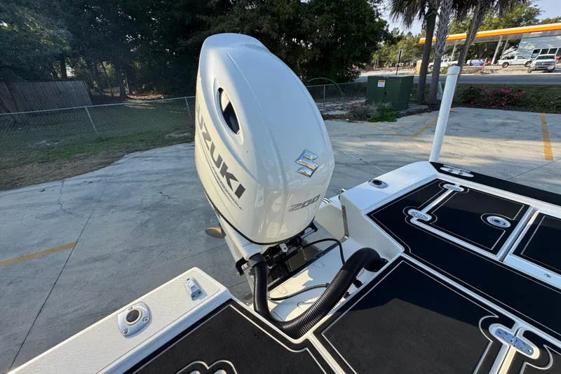 Slide: The Image of 2021 Sea Born FX24 Bay boat with Suzuki 200 outboard motor in a parking area. - 36