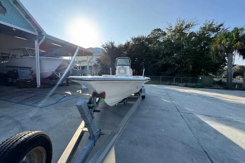 Slide: The Image of 2021 Sea Born FX24 Bay boat on trailer in sunny outdoor setting. - 5