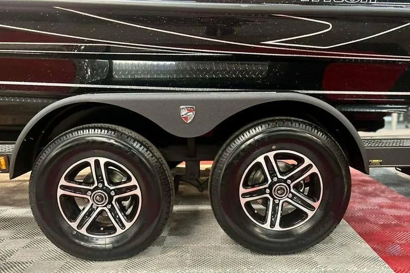 Slide: The Image of 2026 Triton 19 TrX Patriot trailer with dual black alloy wheels. - 10