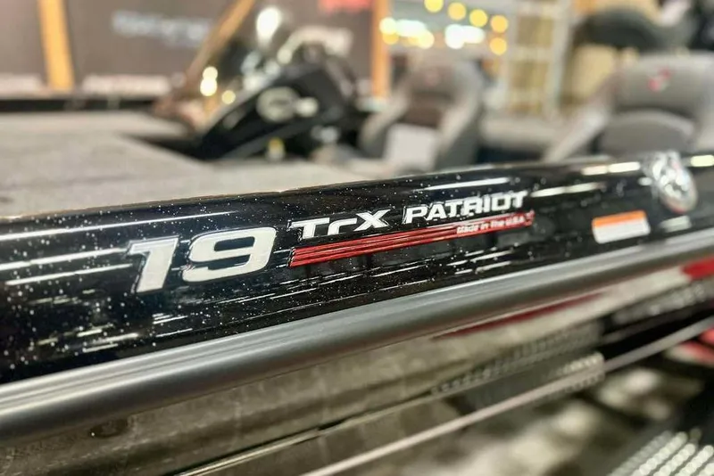 Slide: The Image of 2026 Triton 19 TrX Patriot boat detail showcasing model branding and design. - 12