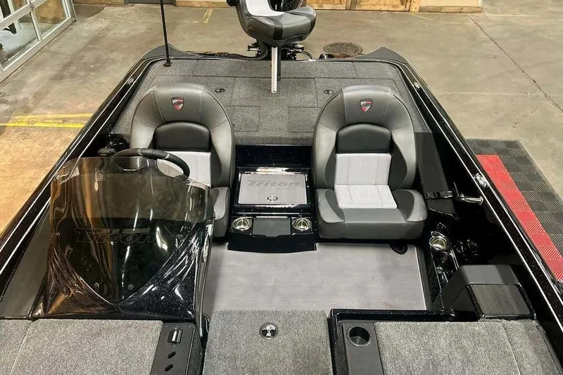 Slide: The Image of 2026 Triton 19 TrX Patriot boat interior with dual seats and steering console. - 15