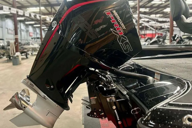 Slide: The Image of 2026 Triton 19 TrX Patriot with Mercury Pro XS engine in showroom setting. - 7