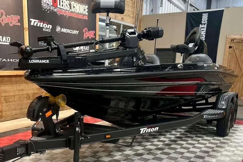 Slide: The Image of 2026 Triton 19 TrX Patriot boat on display with Lowrance equipment. - 8