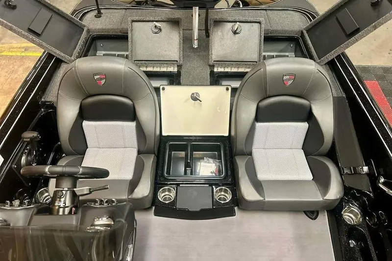 Slide: The Image of 2026 Triton 19 TrX Patriot boat interior with dual seats and storage compartments. - 9