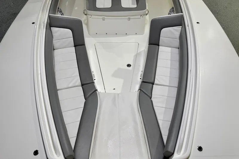 Slide: The Image of 2023 Regulator 28 boat interior with cushioned seating and sleek design. - 22