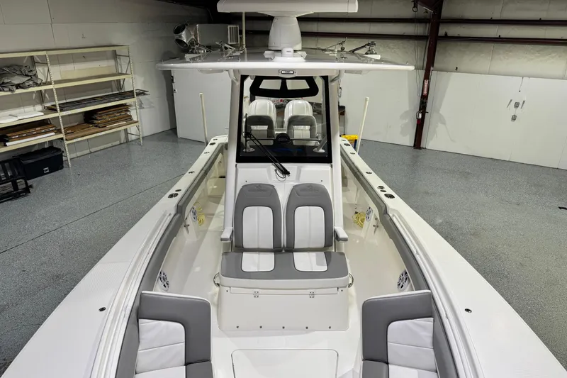 Slide: The Image of 2023 Regulator 28 boat interior with seating, in a spacious indoor storage area. - 23