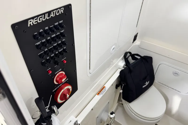 Slide: The Image of Control panel and toilet area inside 2023 Regulator 28 boat cabin. - 25