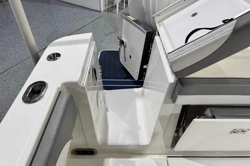 Slide: The Image of 2023 Regulator 28 boat interior with storage compartments and seating. - 29