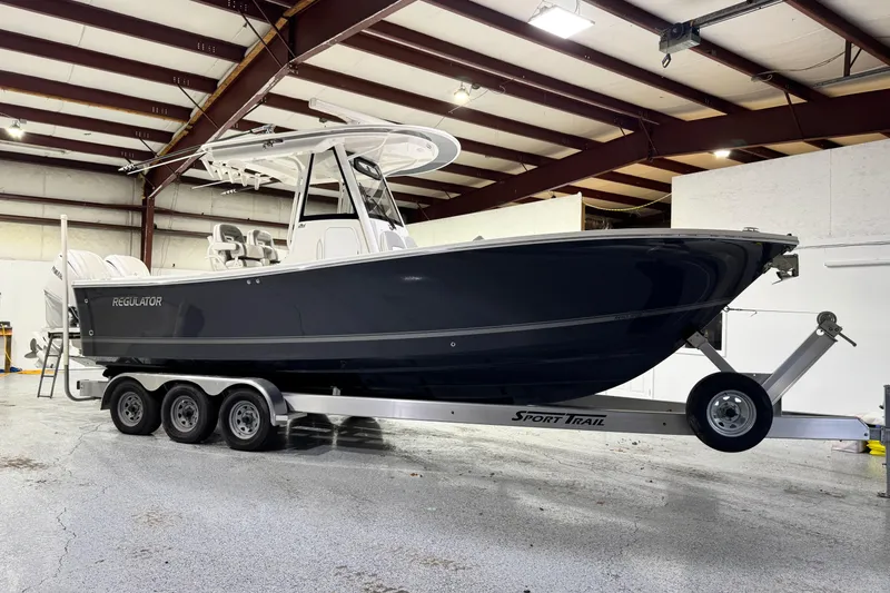 Slide: The Image of 2023 Regulator 28 boat on trailer in indoor storage facility. - 30