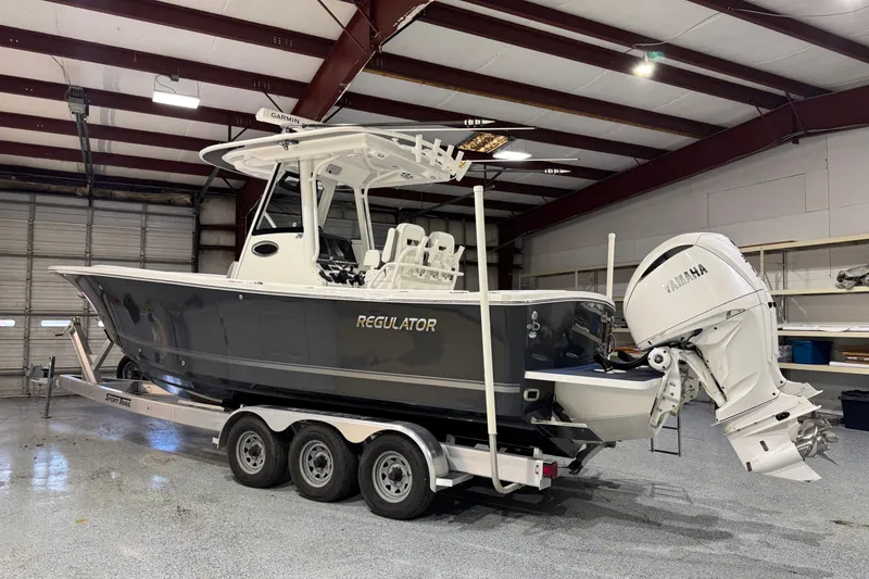 Slide: The Image of 2023 Regulator 28 boat with Yamaha engine in a garage setting. - 4