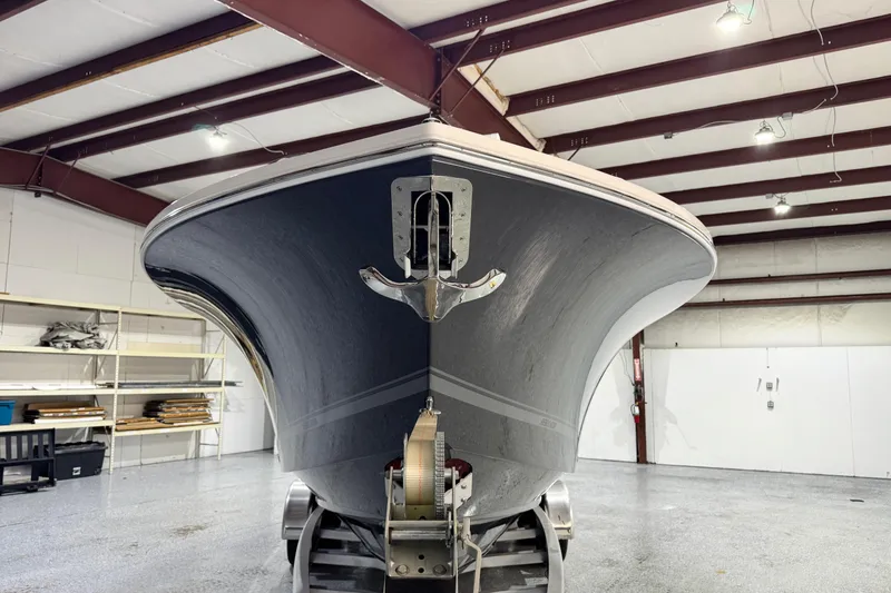Slide: The Image of 2023 Regulator 28 boat in a warehouse, front view with anchor. - 6