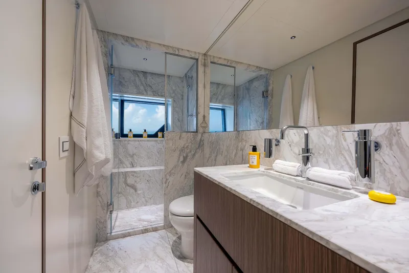 Slide: The Image of Luxurious yacht bathroom with marble finishes, modern fixtures, and large mirror in Alpha Squalo Co Ownership 2025. - 26