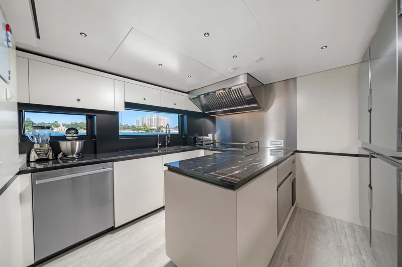Slide: The Image of Modern yacht kitchen with sleek design, stainless steel appliances, and waterfront view. Alpha Squalo Co Ownership 2025. - 36