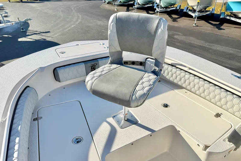 Slide: The Image of 2026 Carolina Skiff 24 Ultra Elite boat interior with cushioned seating and storage compartments. - 12