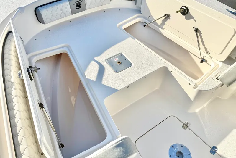 Slide: The Image of 2026 Carolina Skiff 24 Ultra Elite boat interior with open storage compartments. - 17