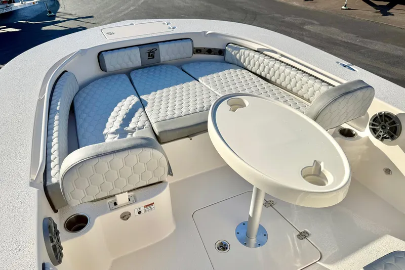 Slide: The Image of 2026 Carolina Skiff 24 Ultra Elite boat interior with cushioned seating and round table. - 19