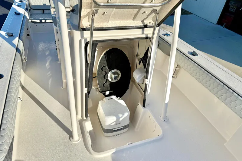 Slide: The Image of 2026 Carolina Skiff 24 Ultra Elite boat interior with storage compartment open. - 22