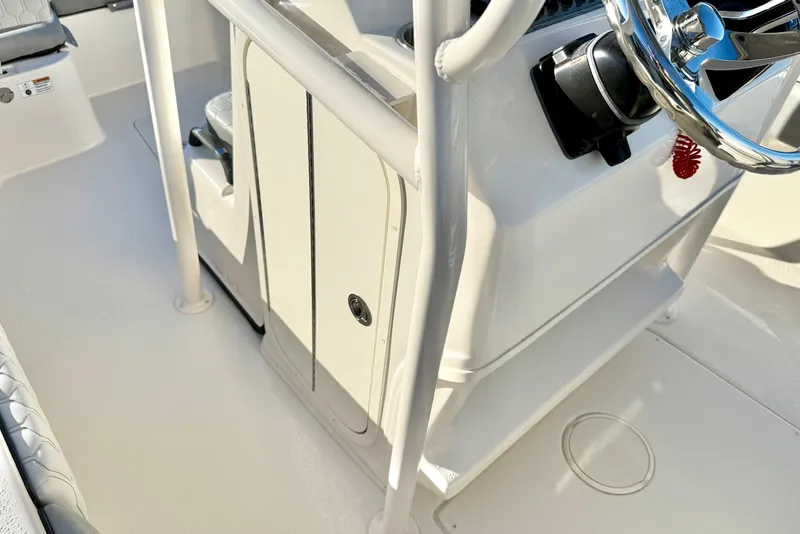 Slide: The Image of 2026 Carolina Skiff 24 Ultra Elite boat interior with steering console and storage. - 23